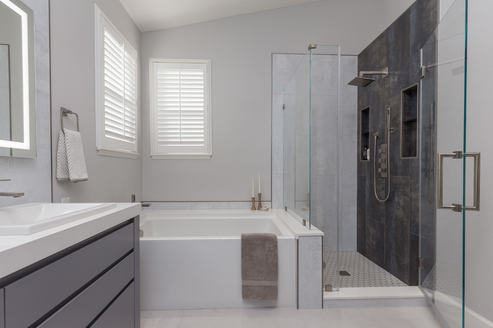 Photo of a large modern master bathroom in San Francisco with flat-panel cabinets, grey cabinets, an undermount tub, a corner shower, a one-piece toilet, gray tile, porcelain tile, grey walls, porcelain floors, an undermount sink, granite benchtops, white floor, a hinged shower door and white benchtops.