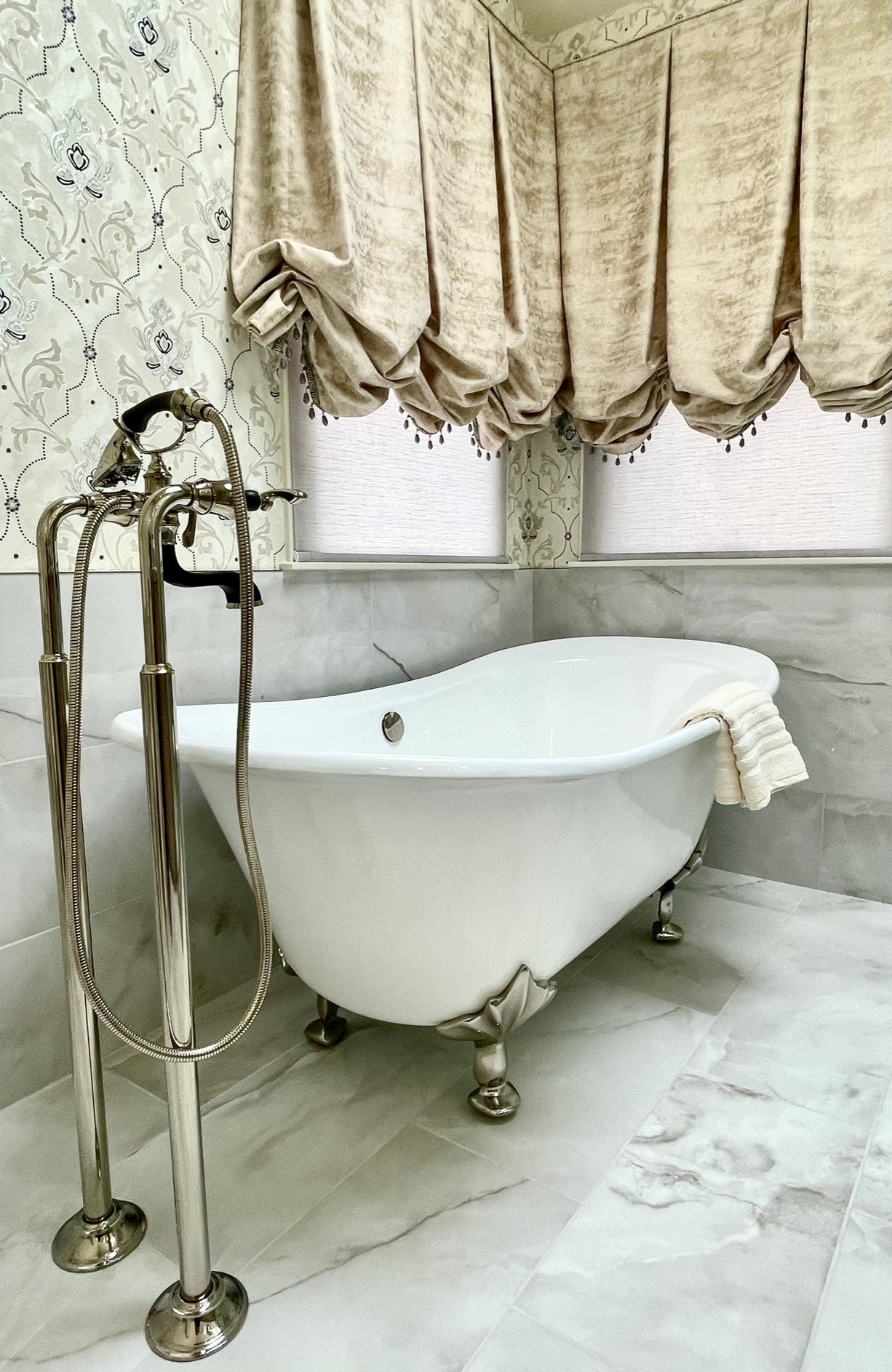 Porcelain floor & wall tile, freestanding sink, custom glass shower, custom window treatment, wallpaper, granite counter top, custom vanity