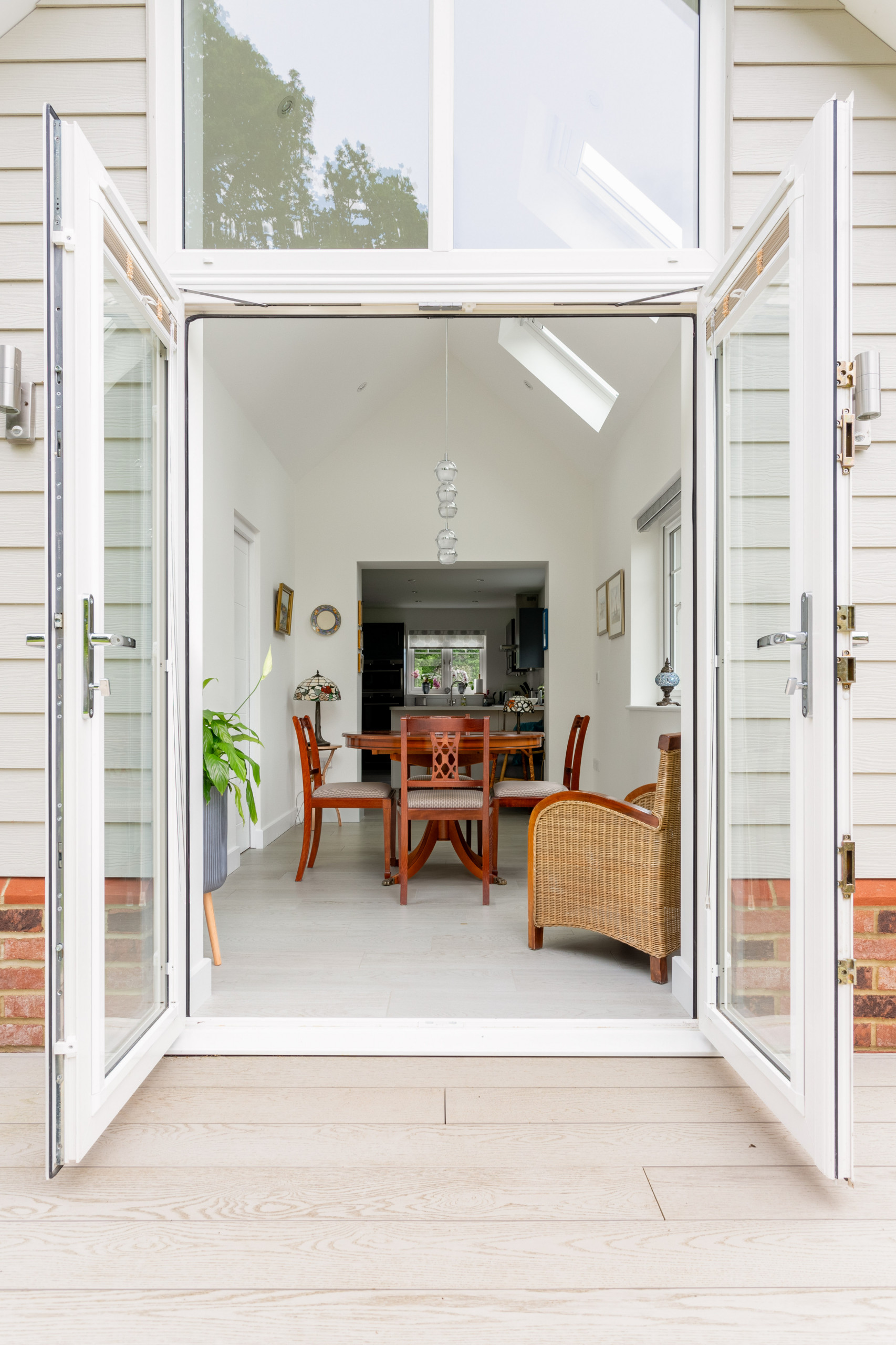 View of extension from garden including extensive glazing and dining space