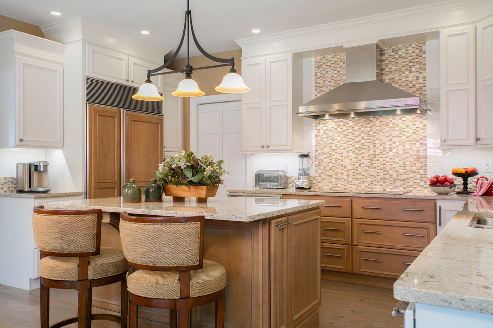 Design ideas for a mid-sized traditional u-shaped kitchen in DC Metro with a double-bowl sink, beaded inset cabinets, white cabinets, beige splashback, stainless steel appliances, medium hardwood floors, with island, granite benchtops, mosaic tile splashback and brown floor.