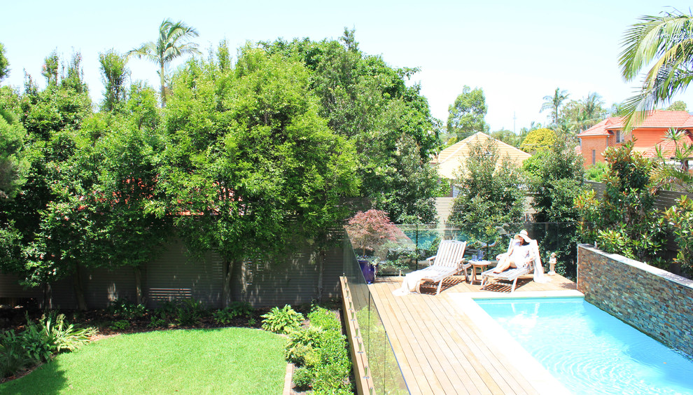 Photo of a mid-sized traditional backyard partial sun garden for spring in Sydney with decking.