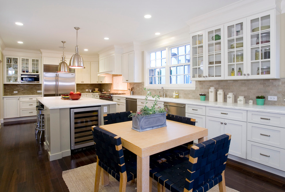 Inspiration for a transitional l-shaped eat-in kitchen in San Francisco with shaker cabinets, white cabinets, grey splashback, subway tile splashback and stainless steel appliances.