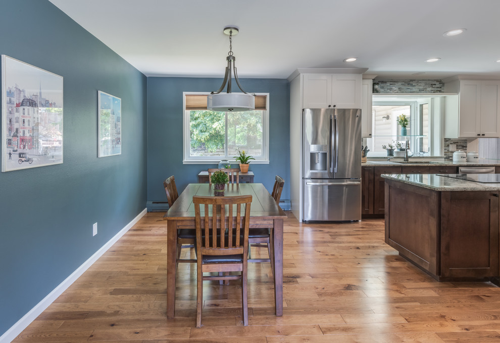 Mid-sized transitional galley medium tone wood floor and brown floor eat-in kitchen photo in Denver with an undermount sink, shaker cabinets, white cabinets, granite countertops, blue backsplash, glass tile backsplash, stainless steel appliances, an island and beige countertops