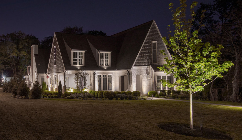 Large contemporary white house exterior in Nashville with painted brick siding, a gable roof and a shingle roof.