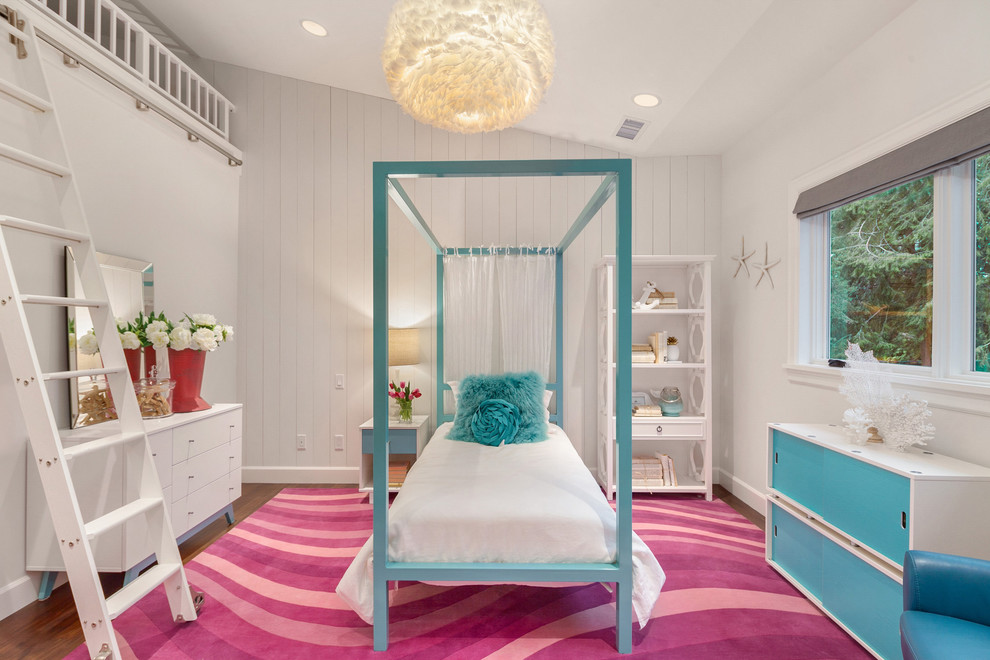 Photo of a mid-sized beach style kids' bedroom for kids 4-10 years old and girls in Seattle with white walls, dark hardwood floors and brown floor.
