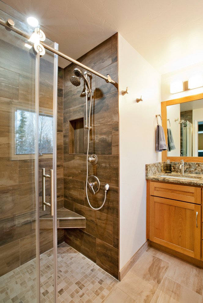 Inspiration for a mid-sized transitional 3/4 beige tile and porcelain tile porcelain tile, beige floor and double-sink alcove shower remodel with shaker cabinets, medium tone wood cabinets, a two-piece toilet, yellow walls, an undermount sink, quartz countertops, brown countertops, a niche and a built-in vanity
