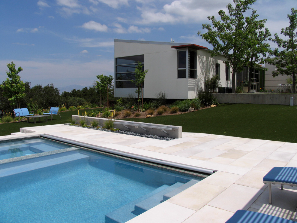 Inspiration for a large contemporary backyard full sun garden in San Francisco with natural stone pavers.