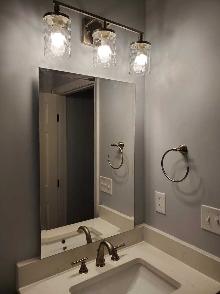 This is an example of a mid-sized modern kids bathroom in Cleveland with flat-panel cabinets, brown cabinets, an alcove shower, a two-piece toilet, white tile, subway tile, beige walls, vinyl floors, an undermount sink, engineered quartz benchtops, grey floor, a sliding shower screen, white benchtops, a laundry, a single vanity and a built-in vanity.