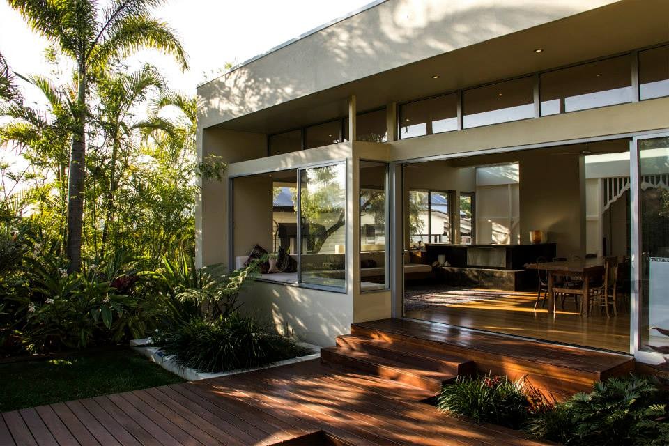 This is an example of a large modern split-level beige exterior in Brisbane.