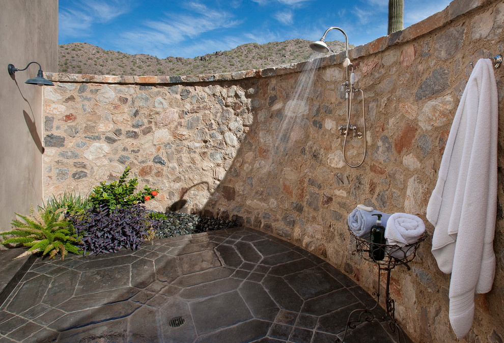 This is an example of a large backyard patio in Phoenix with an outdoor shower, tile and a pergola.