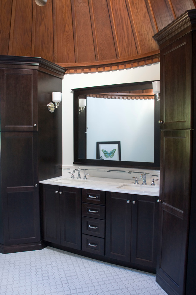 Photo of a mid-sized traditional master bathroom in Other with shaker cabinets, dark wood cabinets, marble benchtops, an alcove shower, white tile, ceramic tile, white walls and ceramic floors.