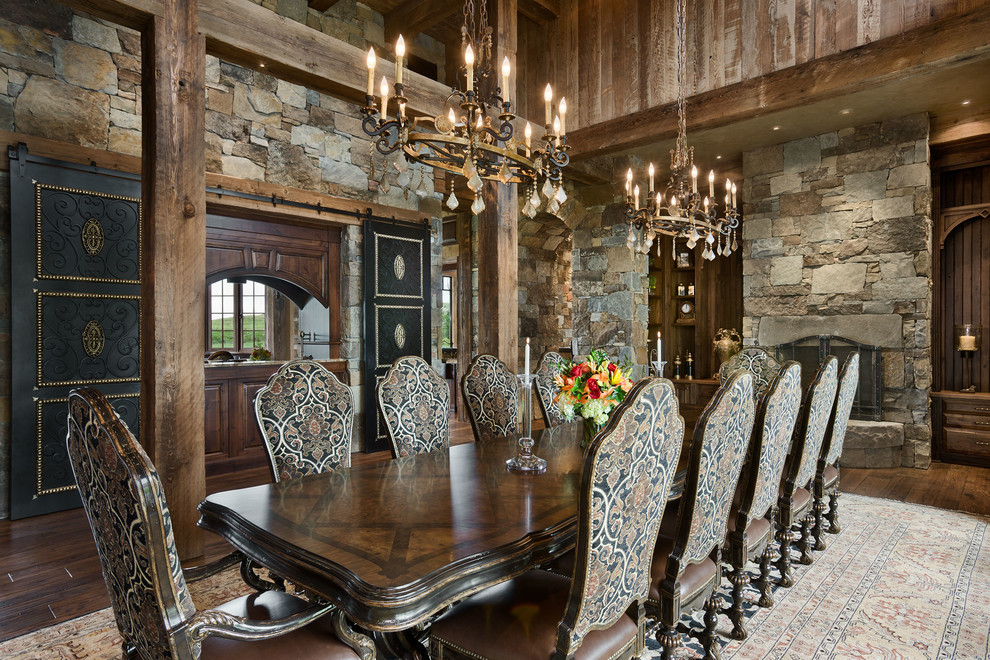 Design ideas for a country dining room in Other with dark hardwood floors and a standard fireplace.