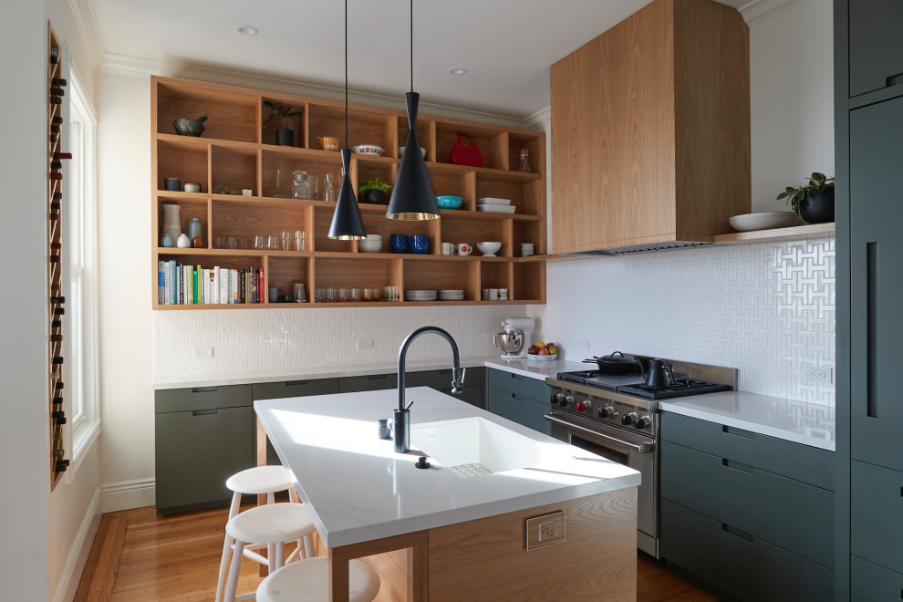 Inspiration for a midcentury l-shaped kitchen in San Francisco with an undermount sink, flat-panel cabinets, quartz benchtops, panelled appliances, medium hardwood floors, with island, white benchtop, grey cabinets, white splashback and brown floor.