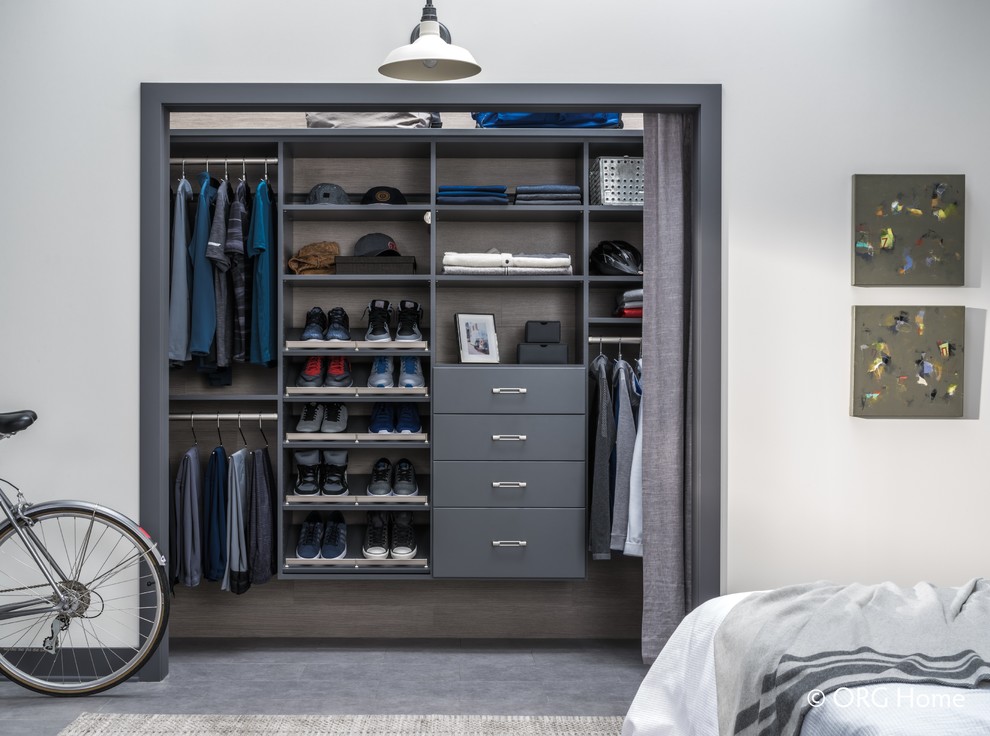 Inspiration for a mid-sized contemporary gender-neutral built-in wardrobe in Other with grey cabinets, porcelain floors and grey floor.