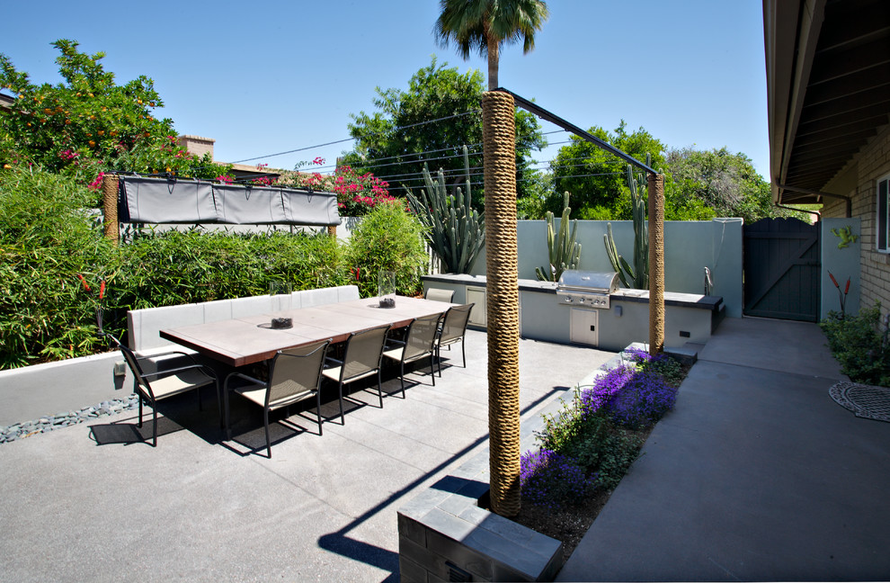 Design ideas for a mid-sized industrial backyard patio in Phoenix with an outdoor kitchen.