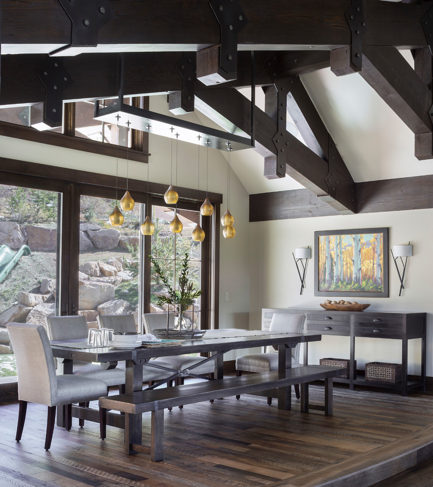Country dining room in Atlanta with beige walls, medium hardwood floors and brown floor.