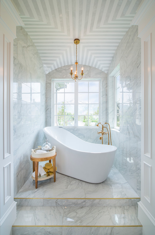 This is an example of a mid-sized contemporary master bathroom in Salt Lake City with white tile, marble floors, a japanese tub, marble, white walls and white floor.