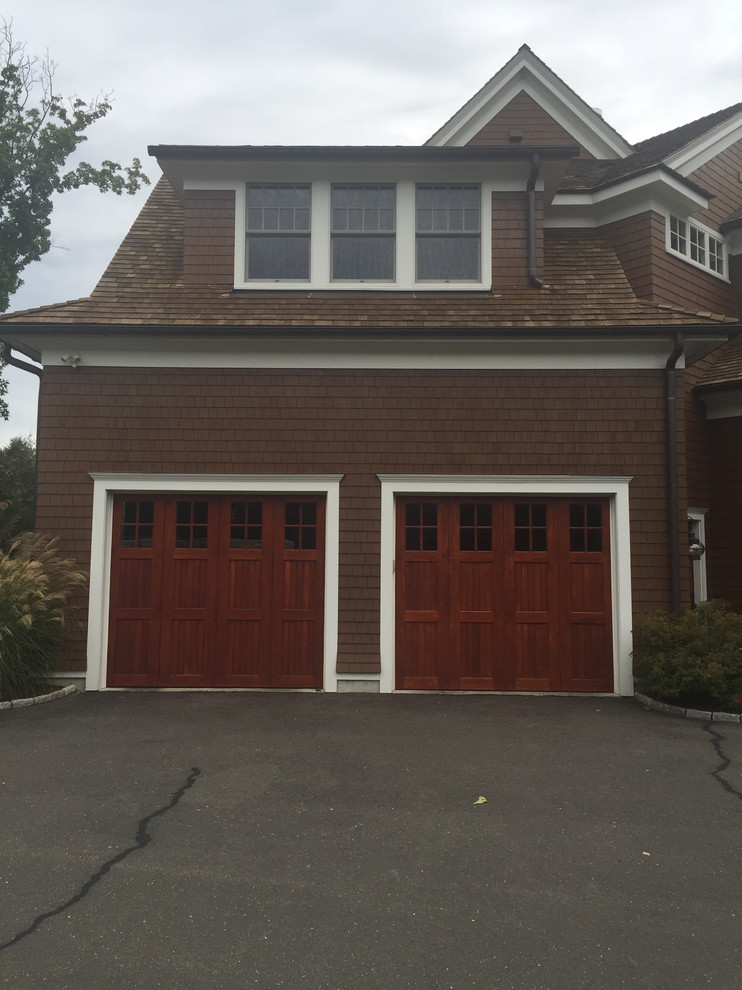 Design ideas for a mid-sized arts and crafts attached two-car garage in New York.