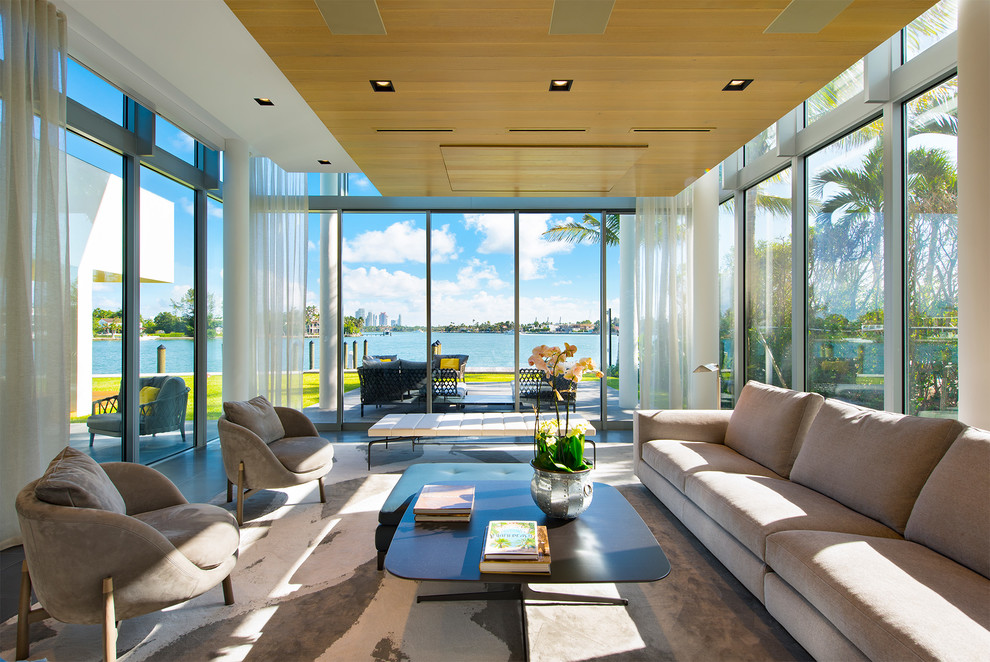 This is an example of an expansive contemporary formal open concept living room in Miami with ceramic floors, no fireplace and a concealed tv.