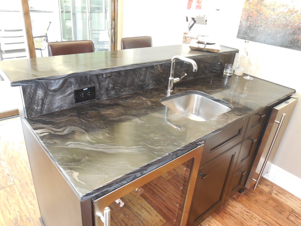 Photo of a contemporary home bar in Austin with an undermount sink and granite benchtops.