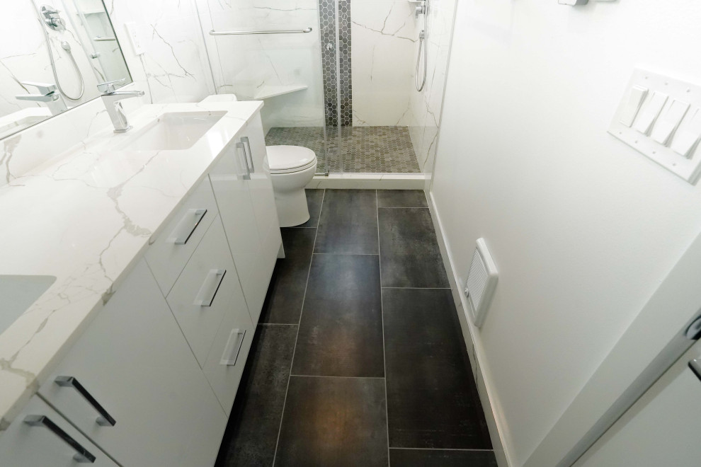 Mid-sized trendy 3/4 white tile and marble tile double-sink, vinyl floor and brown floor sliding shower door photo in Seattle with white cabinets, a one-piece toilet, white walls, quartzite countertops, white countertops and a freestanding vanity