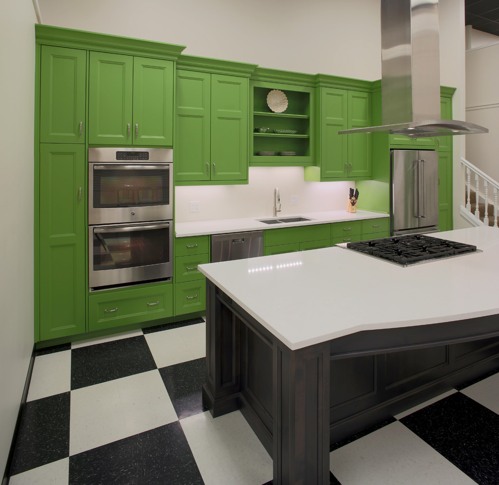 Example of a mid-sized transitional galley open concept kitchen design with an undermount sink, recessed-panel cabinets, green cabinets, quartz countertops, stainless steel appliances and an island