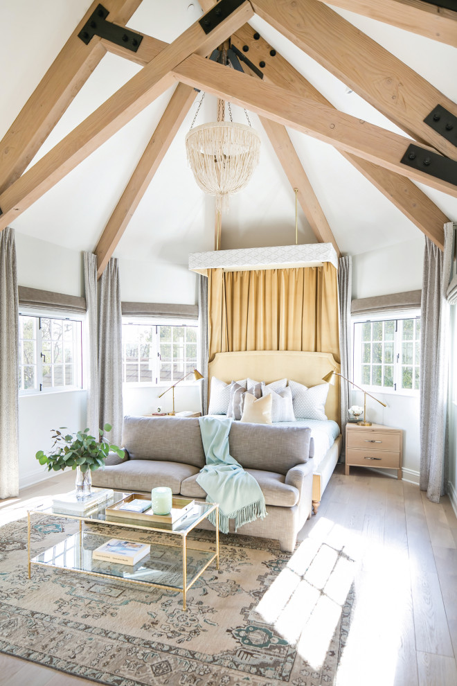 French country master light wood floor and exposed beam bedroom photo in Los Angeles with white walls