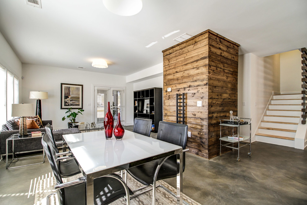 Great room - contemporary concrete floor great room idea in Atlanta with white walls