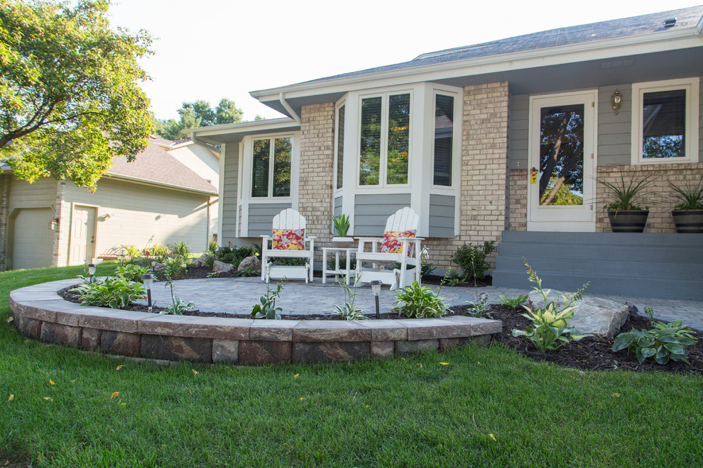 This is an example of a small front yard patio in Minneapolis with concrete pavers.