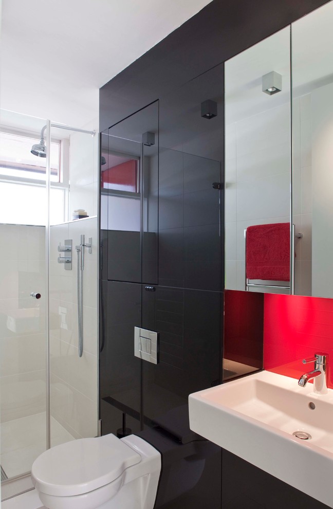 Inspiration for a small modern kids bathroom in London with flat-panel cabinets, black cabinets, a curbless shower, a wall-mount toilet, beige tile, porcelain tile, red walls, porcelain floors and a wall-mount sink.
