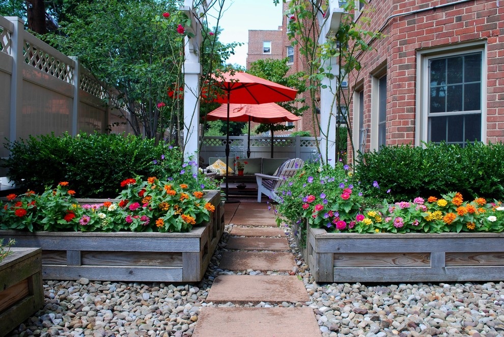 This is an example of a mid-sized transitional rooftop full sun garden for summer in Cleveland with a container garden.