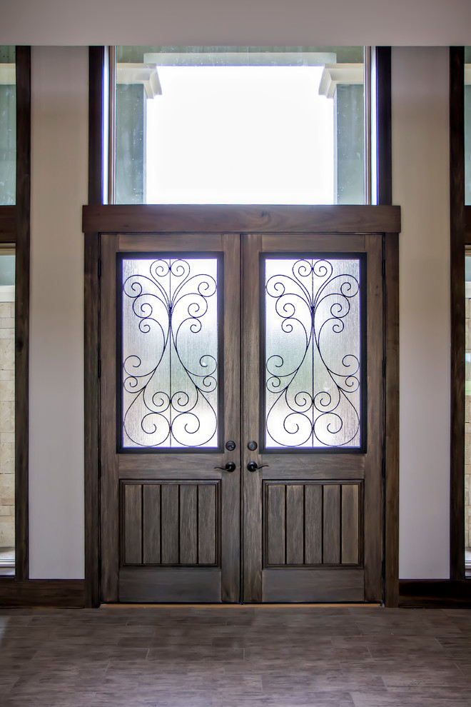 Photo of a mid-sized beach style front door in Jacksonville with white walls, a double front door, a dark wood front door and ceramic floors.