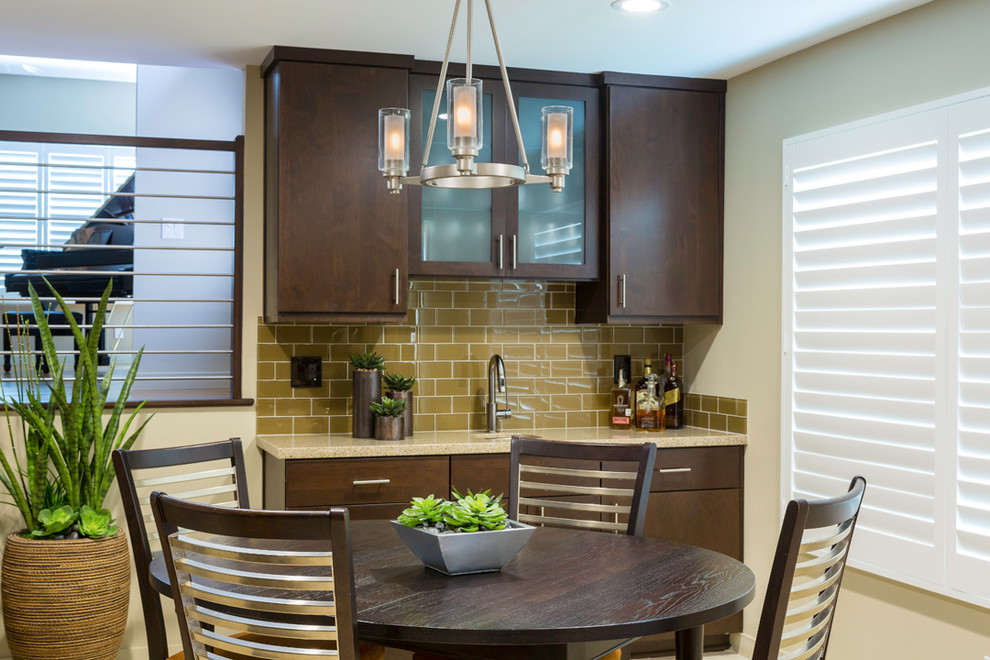 Inspiration for a large transitional u-shaped ceramic tile and white floor eat-in kitchen remodel in Orange County with an undermount sink, flat-panel cabinets, dark wood cabinets, granite countertops, brown backsplash, subway tile backsplash, stainless steel appliances, beige walls and an island