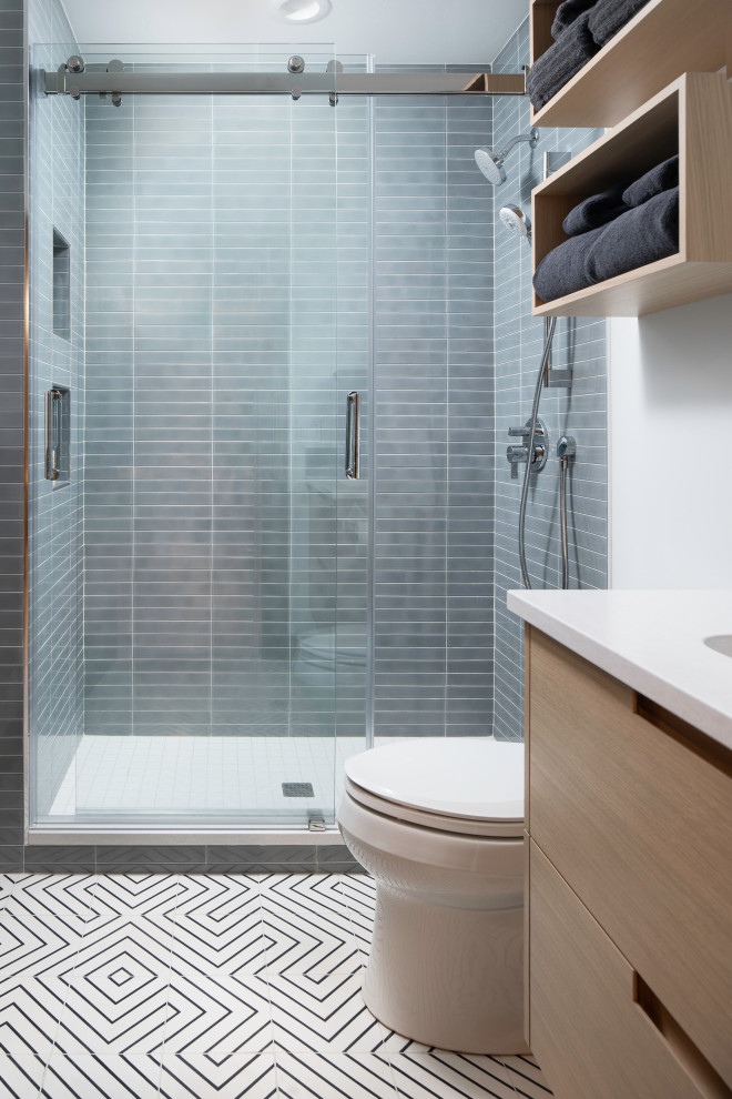 Small minimalist 3/4 gray tile and ceramic tile cement tile floor and single-sink bathroom photo in Denver with flat-panel cabinets, light wood cabinets, a two-piece toilet, white walls, an undermount sink, quartz countertops, white countertops and a floating vanity