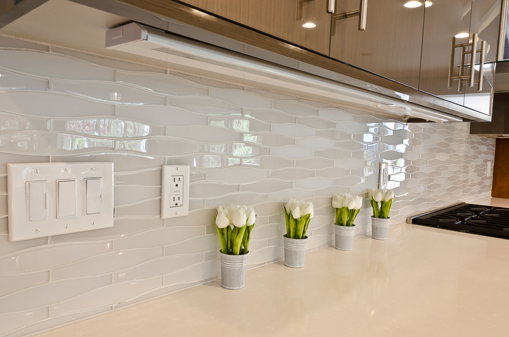 Photo of a contemporary kitchen in New York with white splashback and glass tile splashback.