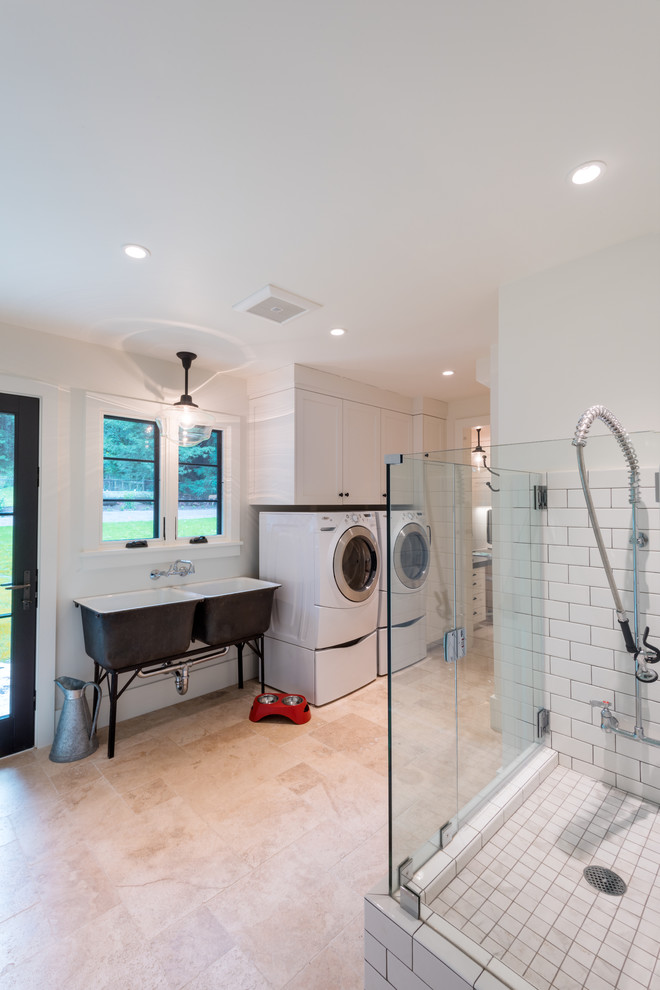Inspiration for a large country single-wall utility room in San Francisco with an utility sink, shaker cabinets, white cabinets, a side-by-side washer and dryer, white walls, porcelain floors and beige floor.