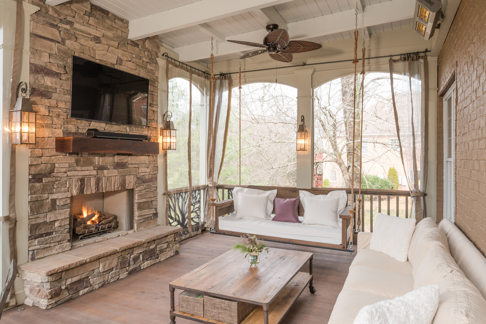 Photo of a country deck in Nashville with a fire feature and a roof extension.