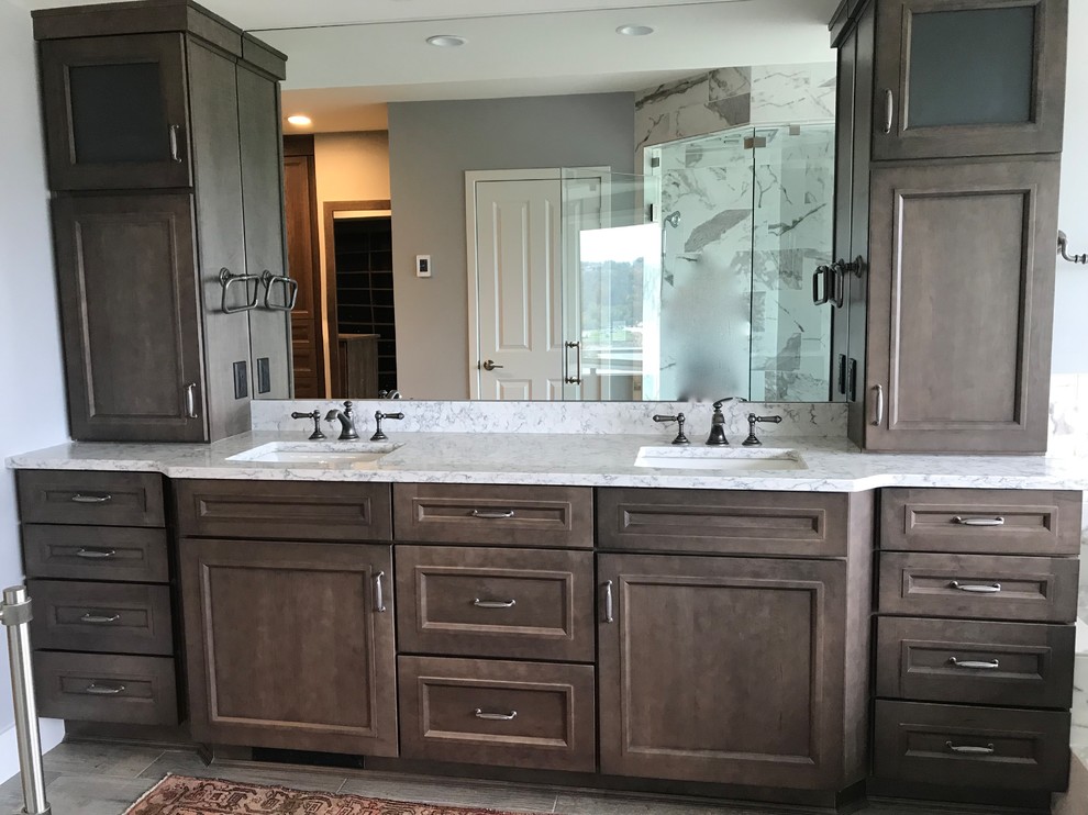 Mid-sized transitional master gray tile and marble tile porcelain tile and gray floor wet room photo in Cincinnati with recessed-panel cabinets, gray cabinets, an undermount tub, a two-piece toilet, gray walls, an undermount sink, granite countertops, a hinged shower door and gray countertops