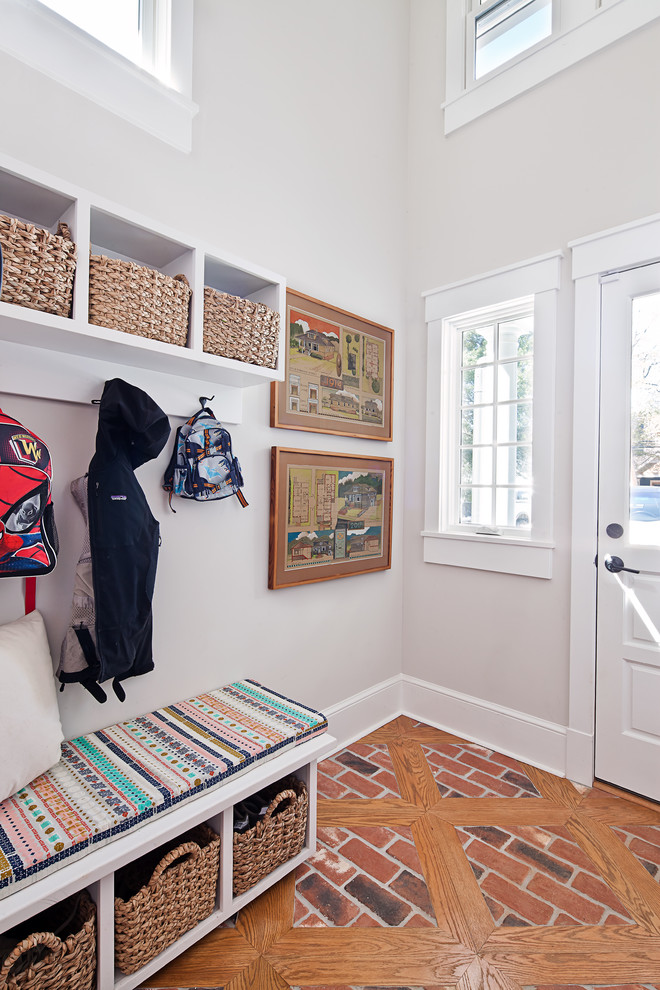 Inspiration for a small transitional mudroom in Charlotte with grey walls, brick floors, a single front door, a white front door and red floor.