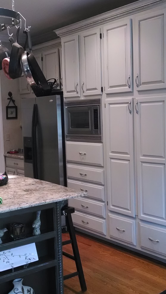 Kitchen - mid-sized traditional u-shaped dark wood floor kitchen idea in Charlotte with recessed-panel cabinets, gray cabinets, granite countertops, stainless steel appliances and an island