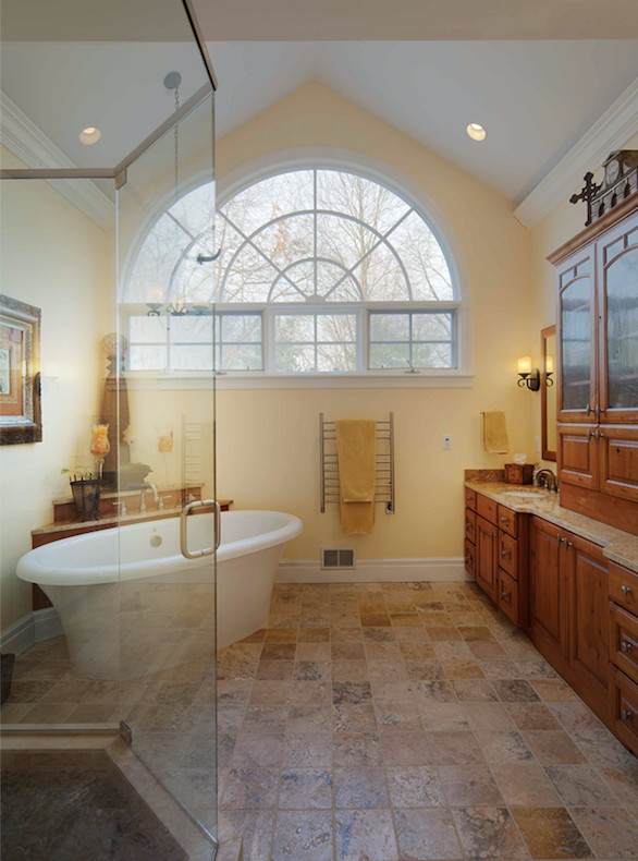 Large traditional master bathroom in Other with medium wood cabinets, yellow walls, a drop-in sink, a hinged shower door, raised-panel cabinets, a two-piece toilet, travertine floors, granite benchtops, beige floor, beige tile, porcelain tile and beige benchtops.