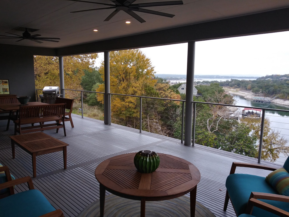 Inspiration for a mid-sized modern balcony in Austin with a roof extension and cable railing.