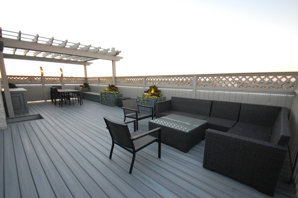 Example of a large transitional rooftop outdoor kitchen deck design in Chicago with a pergola