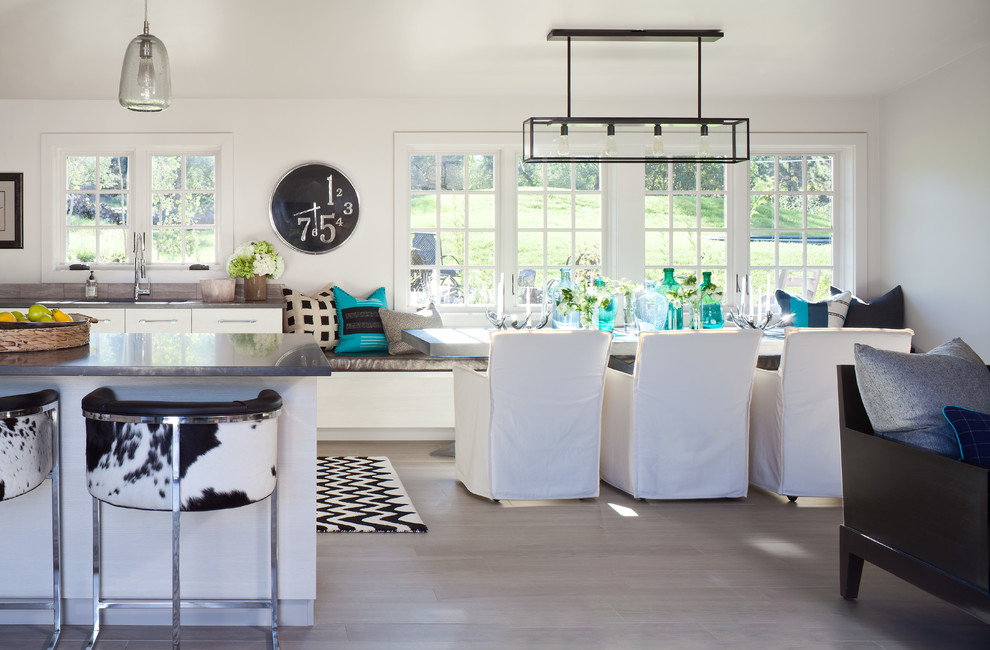 Inspiration for a small beach style open plan dining in Denver with white walls and light hardwood floors.