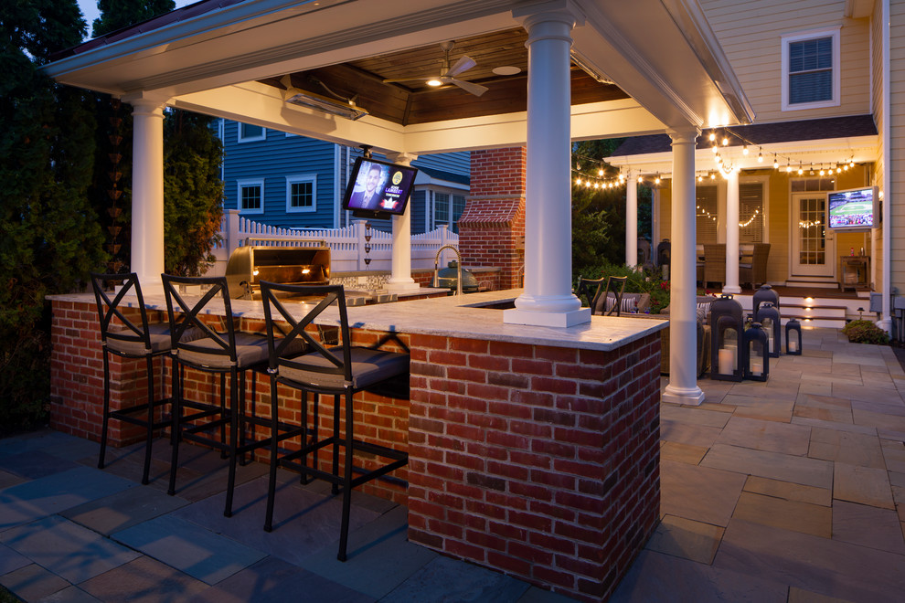 Design ideas for a large traditional backyard patio in Philadelphia with an outdoor kitchen, tile and a gazebo/cabana.