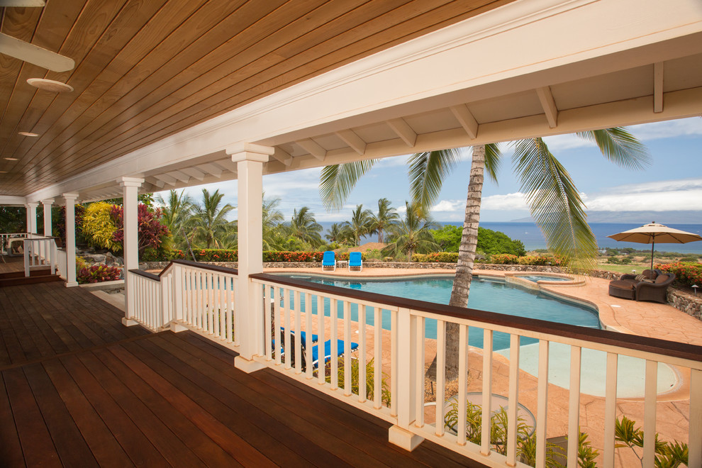 Large beach style front yard verandah in Hawaii with decking and a roof extension.