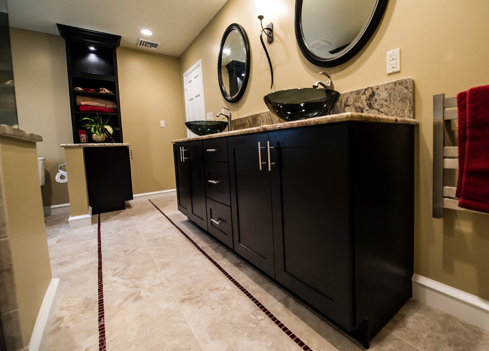 Photo of a large contemporary master bathroom in Philadelphia with a vessel sink, shaker cabinets, dark wood cabinets, granite benchtops, a double shower, a two-piece toilet, beige tile, porcelain tile, beige walls and porcelain floors.