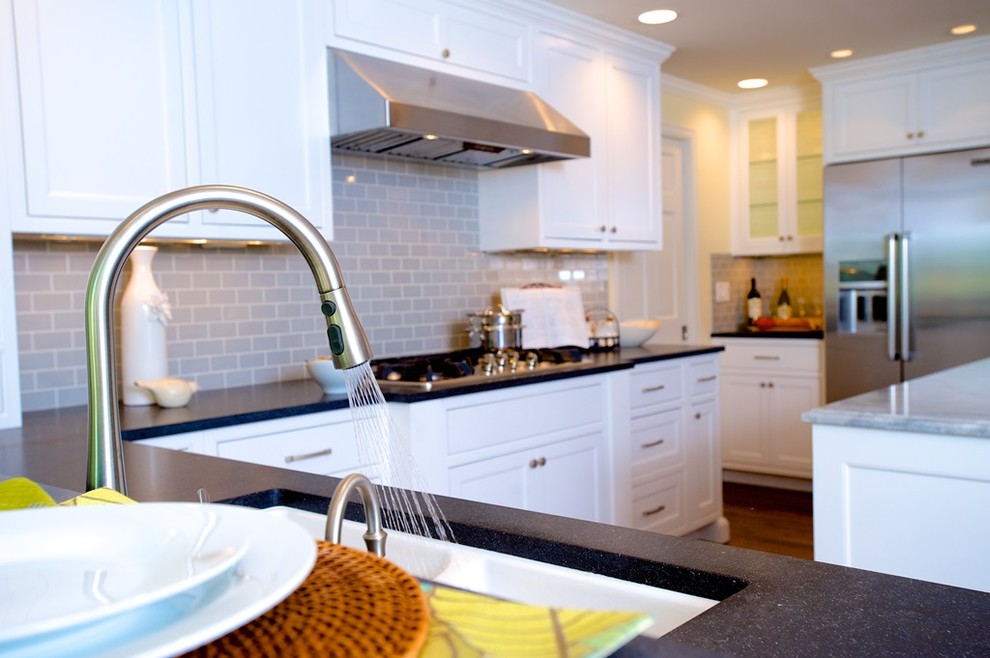Eat-in kitchen - large transitional u-shaped dark wood floor eat-in kitchen idea in Seattle with an undermount sink, shaker cabinets, white cabinets, quartz countertops, beige backsplash, glass tile backsplash, stainless steel appliances and an island