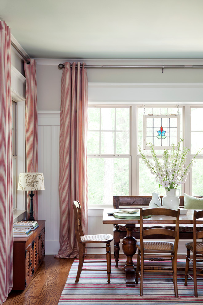Inspiration for a traditional dining room in Little Rock with grey walls and dark hardwood floors.