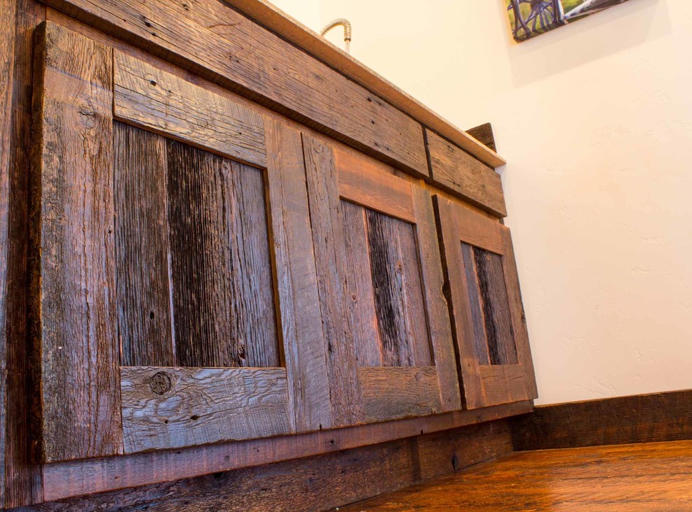 Inspiration for a rustic single-wall kitchen remodel with flat-panel cabinets, dark wood cabinets and laminate countertops